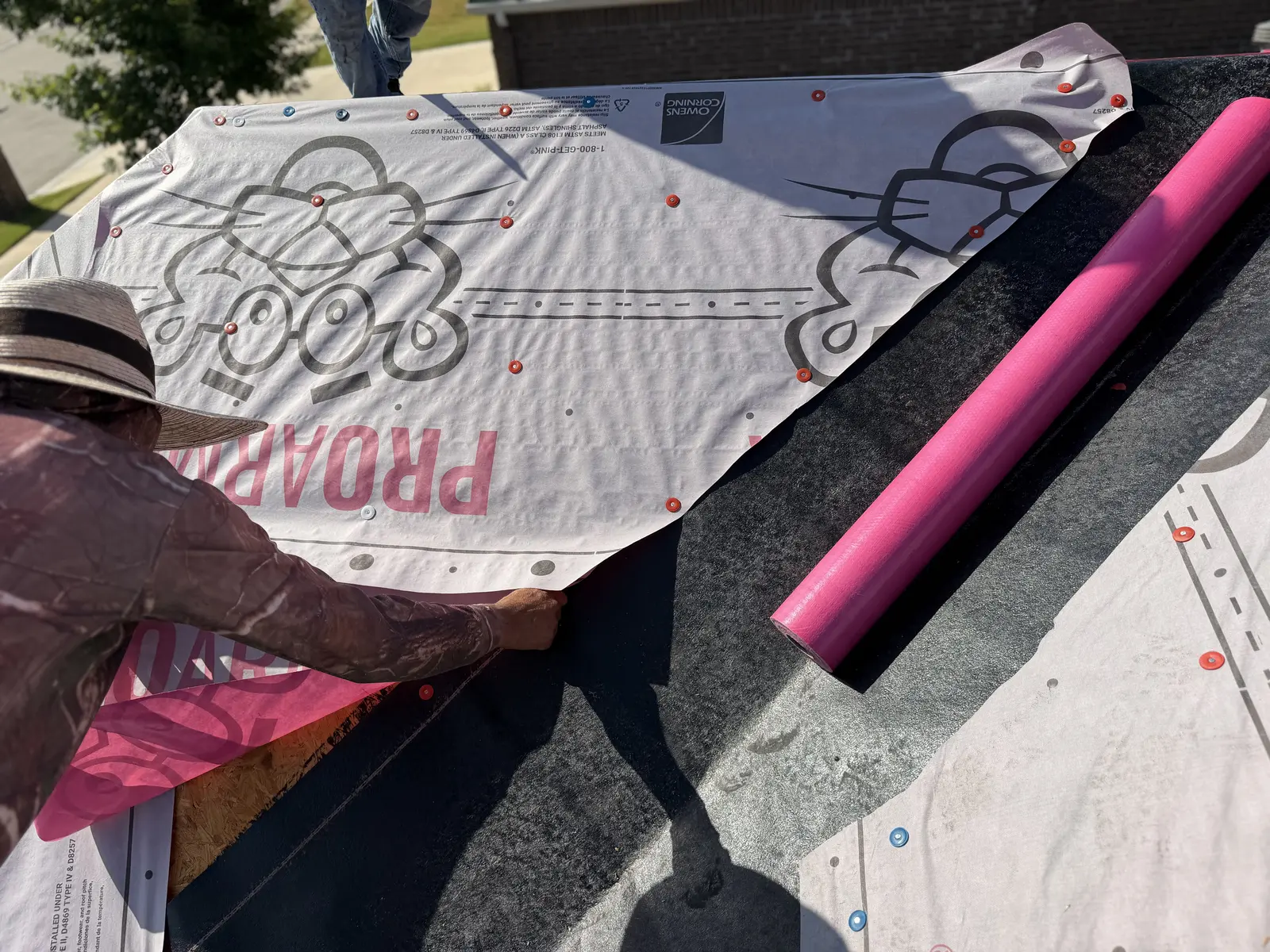 Roofing underlayment and protective materials being installed at the Fort Worth project